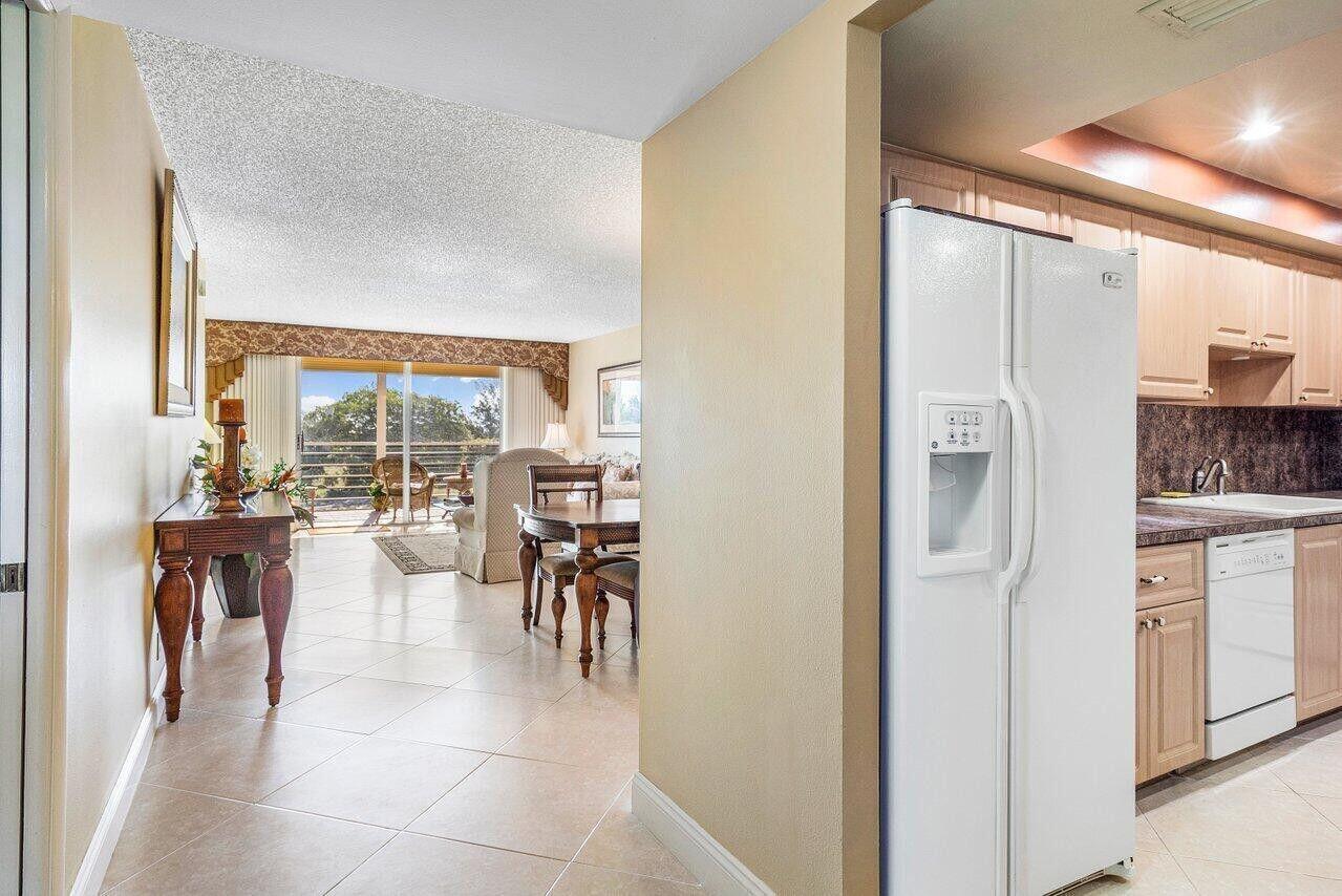 6200 Northwest 2nd Avenue, Unit 415 Boca Raton, FL 33487 - Photo 14 of 31 a dining hall with stainless steel appliances kitchen island granite countertop a refrigerator and cabinets
