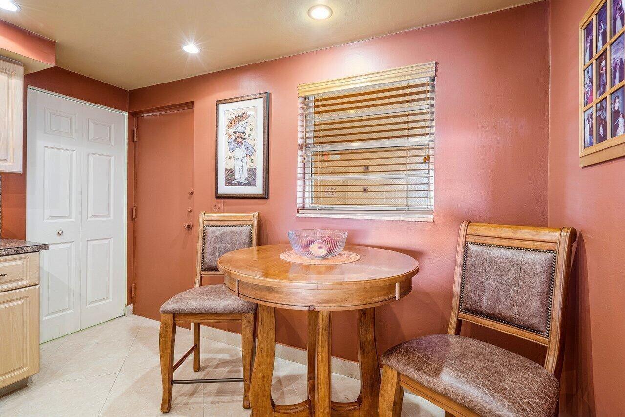 6200 Northwest 2nd Avenue, Unit 415 Boca Raton, FL 33487 - Photo 17 of 31 a dining room with a table and chairs