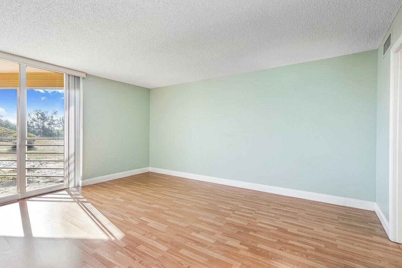 6200 Northwest 2nd Avenue, Unit 415 Boca Raton, FL 33487 - Photo 18 of 31 a view of an empty room with wooden floor and a window