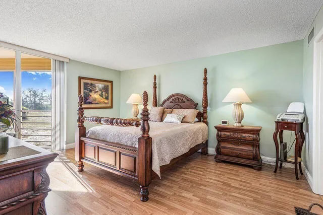 a bedroom with a bed a lamp and a window