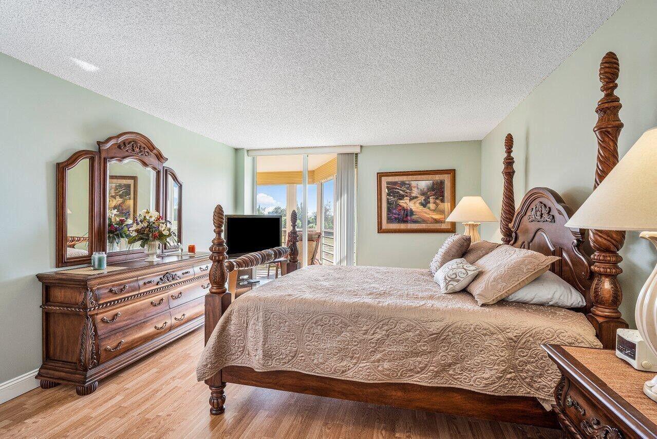 6200 Northwest 2nd Avenue, Unit 415 Boca Raton, FL 33487 - Photo 20 of 31 a bedroom with a bed and wooden floor