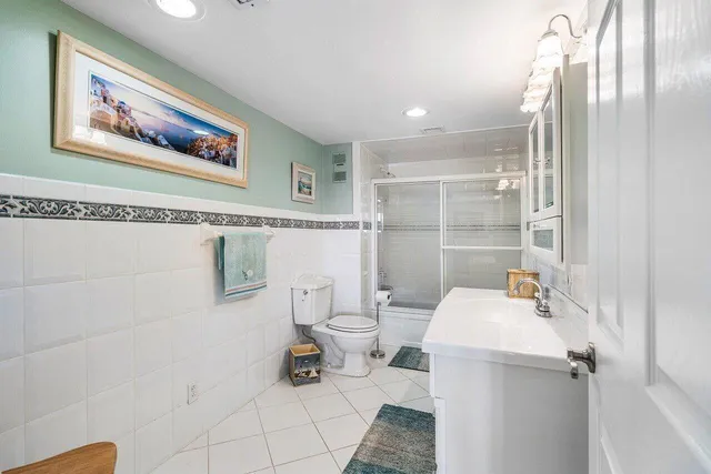 a bathroom with a sink mirror vanity and toilet
