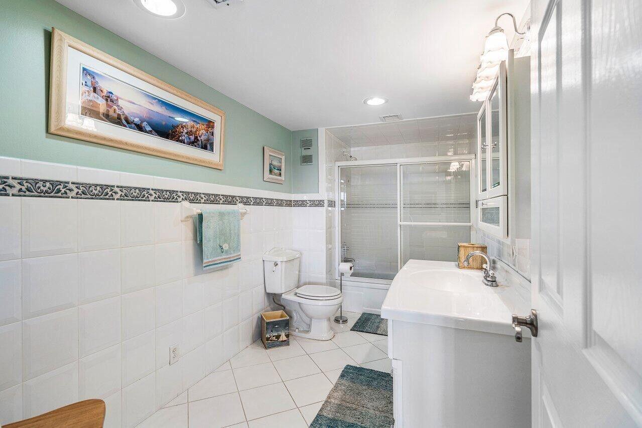 6200 Northwest 2nd Avenue, Unit 415 Boca Raton, FL 33487 - Photo 21 of 31 a bathroom with a sink mirror vanity and toilet