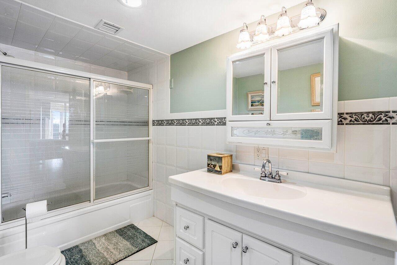 6200 Northwest 2nd Avenue, Unit 415 Boca Raton, FL 33487 - Photo 22 of 31 a bathroom with a sink and a mirror