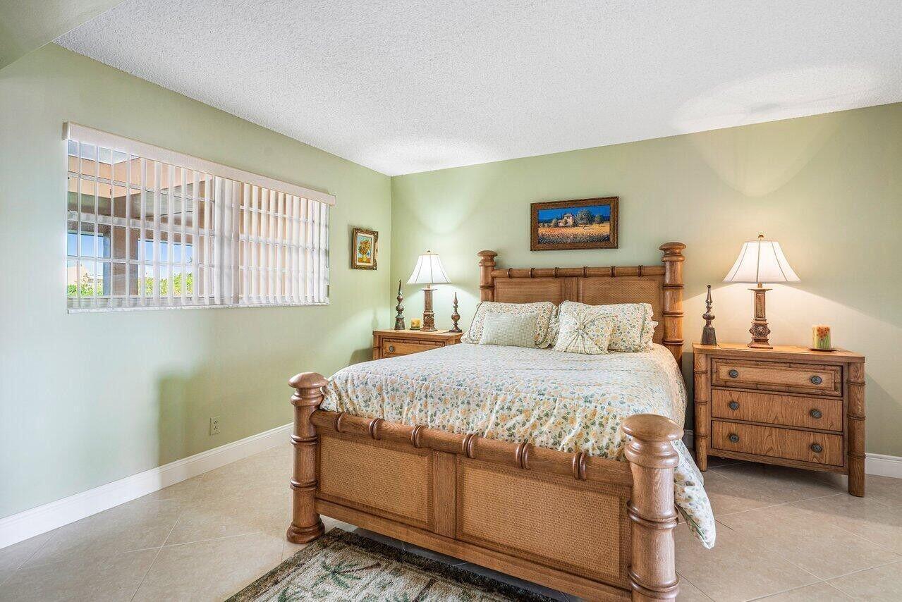 6200 Northwest 2nd Avenue, Unit 415 Boca Raton, FL 33487 - Photo 24 of 31 a bedroom with a bed and a night stand