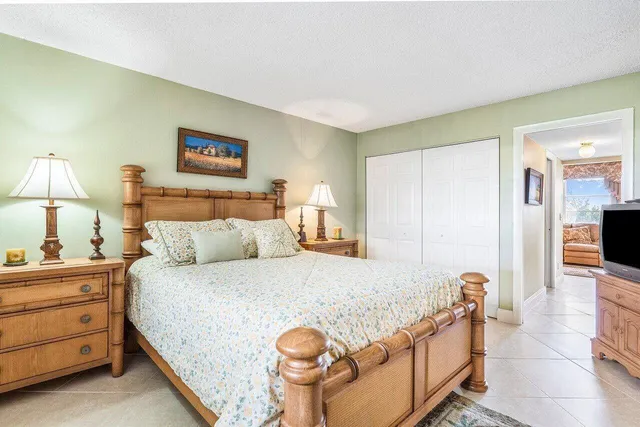 a bedroom with a bed and a lamp on table