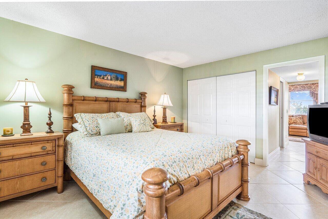 6200 Northwest 2nd Avenue, Unit 415 Boca Raton, FL 33487 - Photo 25 of 31 a bedroom with a bed and a lamp on table