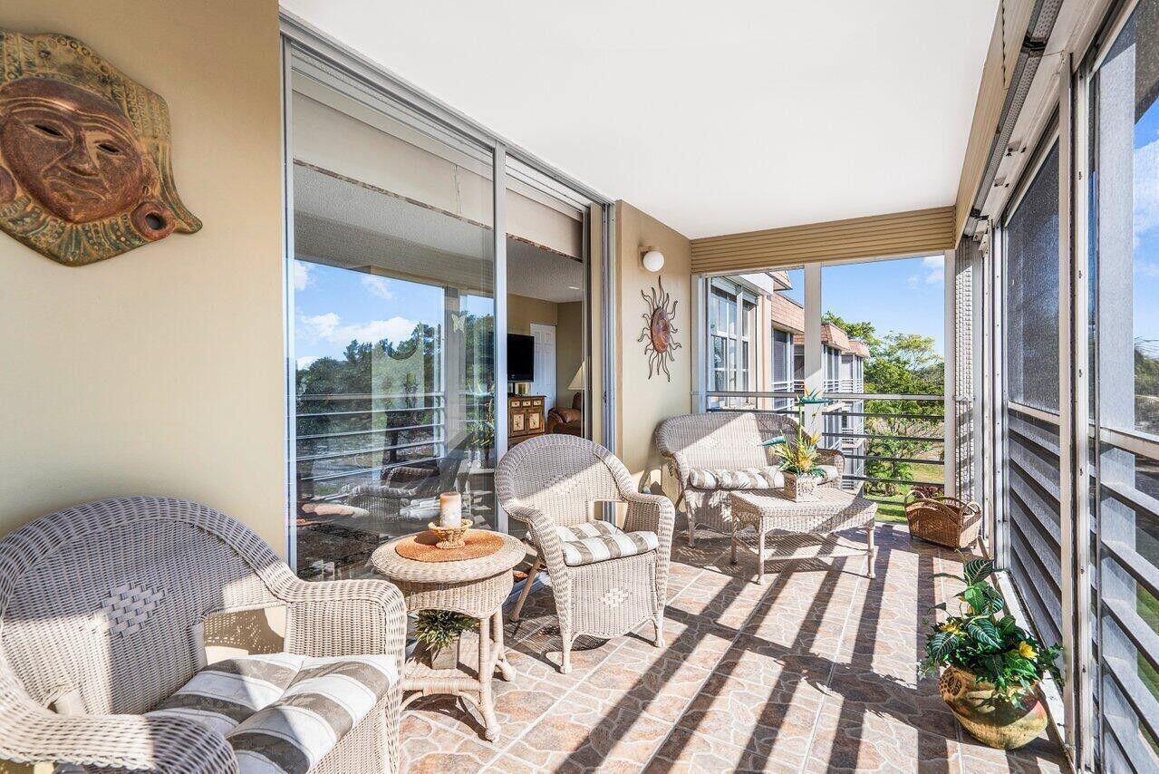 6200 Northwest 2nd Avenue, Unit 415 Boca Raton, FL 33487 - Photo 28 of 31 a living room with patio furniture and a large window