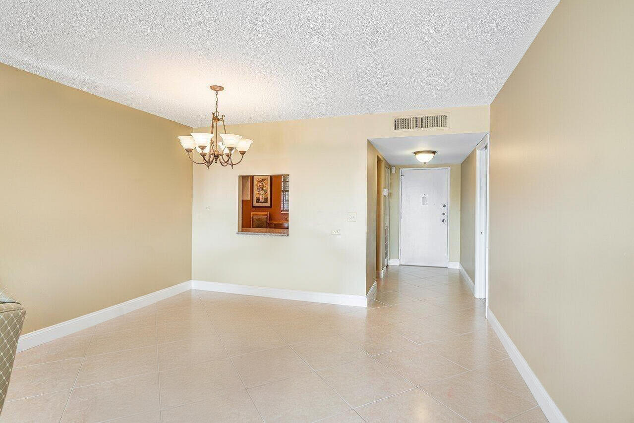 6200 Northwest 2nd Avenue, Unit 415 Boca Raton, FL 33487 - Photo 5 of 31 a view of a hallway with a chandelier