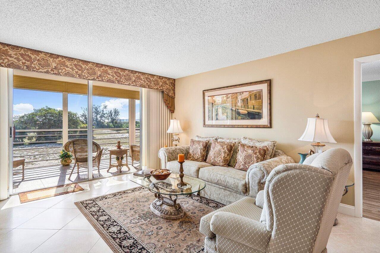 6200 Northwest 2nd Avenue, Unit 415 Boca Raton, FL 33487 - Photo 9 of 31 a living room with furniture and a large window