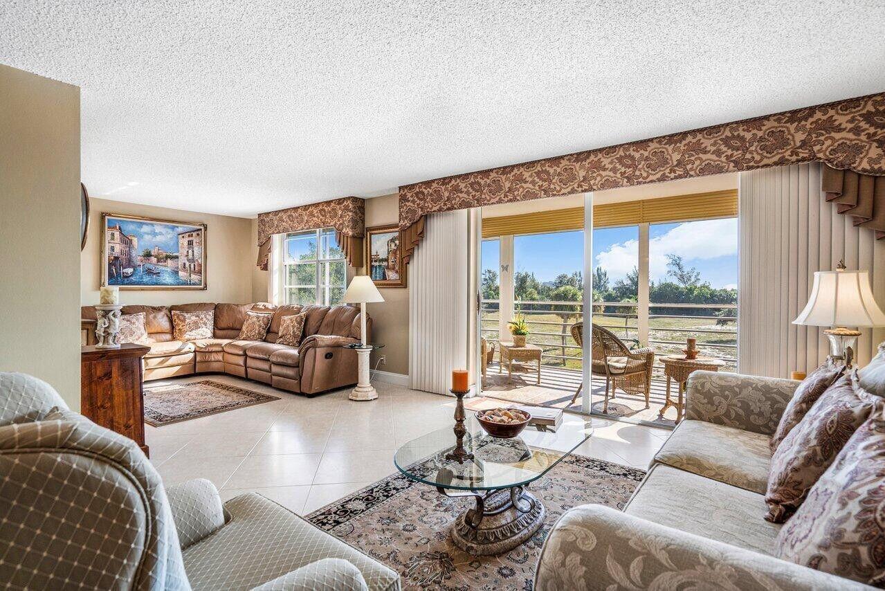 6200 Northwest 2nd Avenue, Unit 415 Boca Raton, FL 33487 - Photo 10 of 31 a living room with furniture and a large window