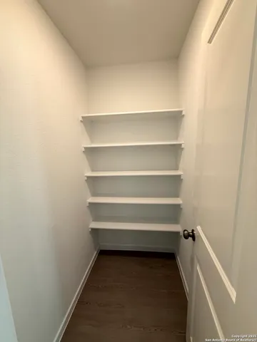a view of walk in closet with empty racks