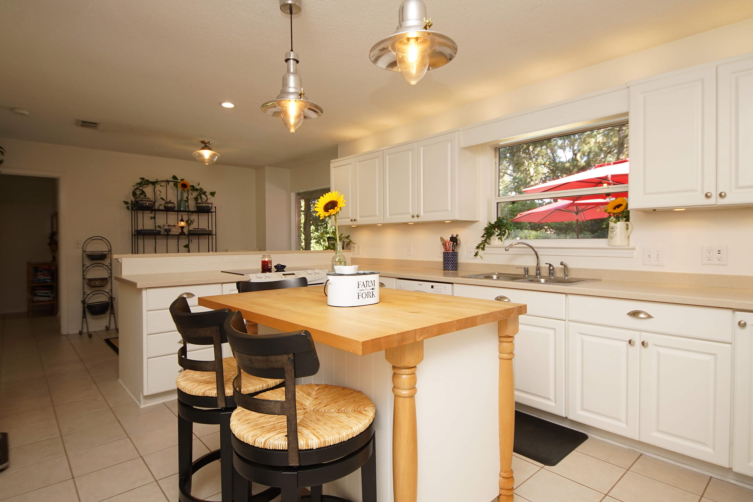 216 Country Club Road Shalimar, FL 32579 - Photo 17 of 59 a kitchen with stainless steel appliances granite countertop a sink a stove a dining table and chairs