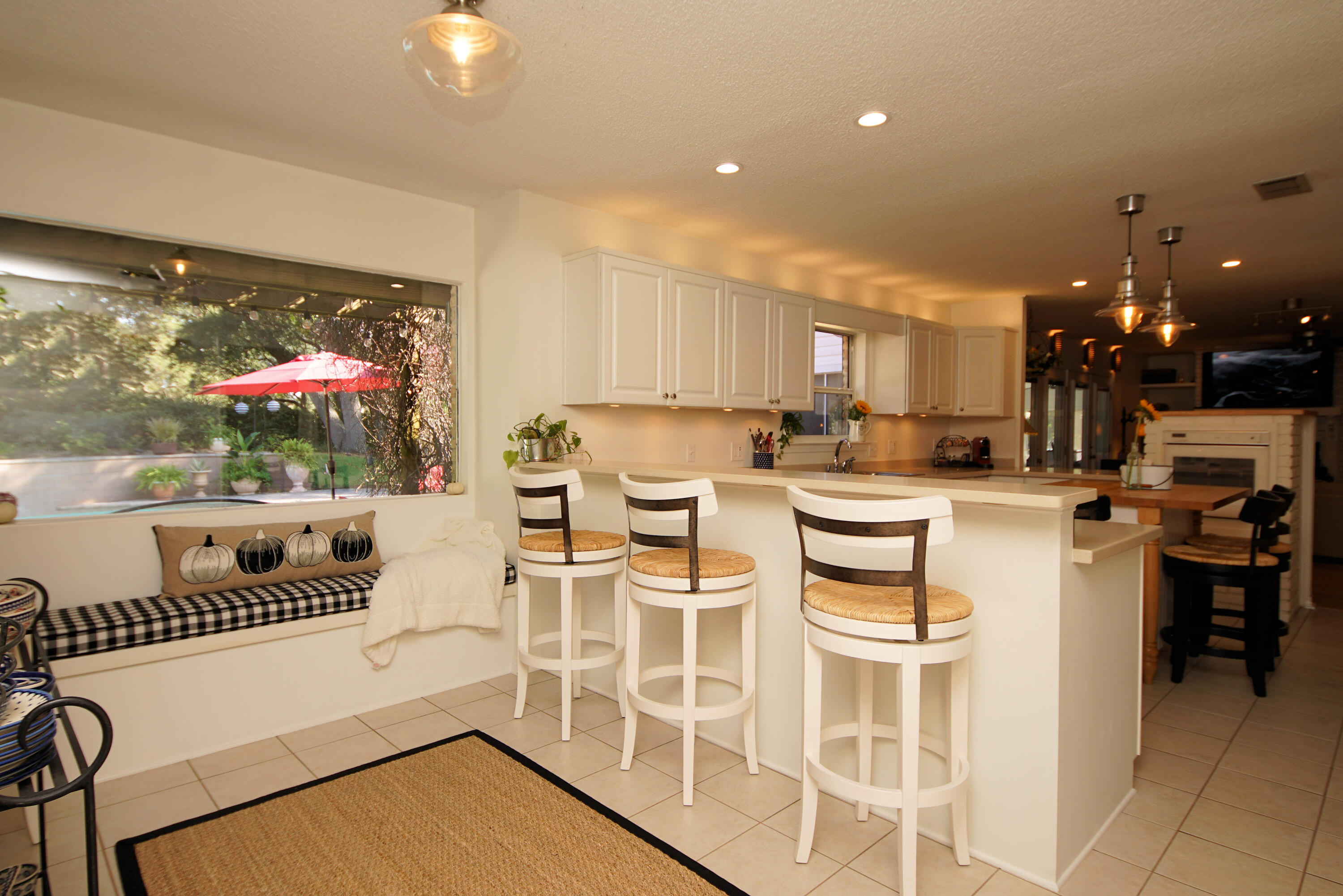 216 Country Club Road Shalimar, FL 32579 - Photo 19 of 59 a kitchen with stainless steel appliances kitchen island granite countertop a stove a refrigerator a sink a dining table and chairs with wooden floor