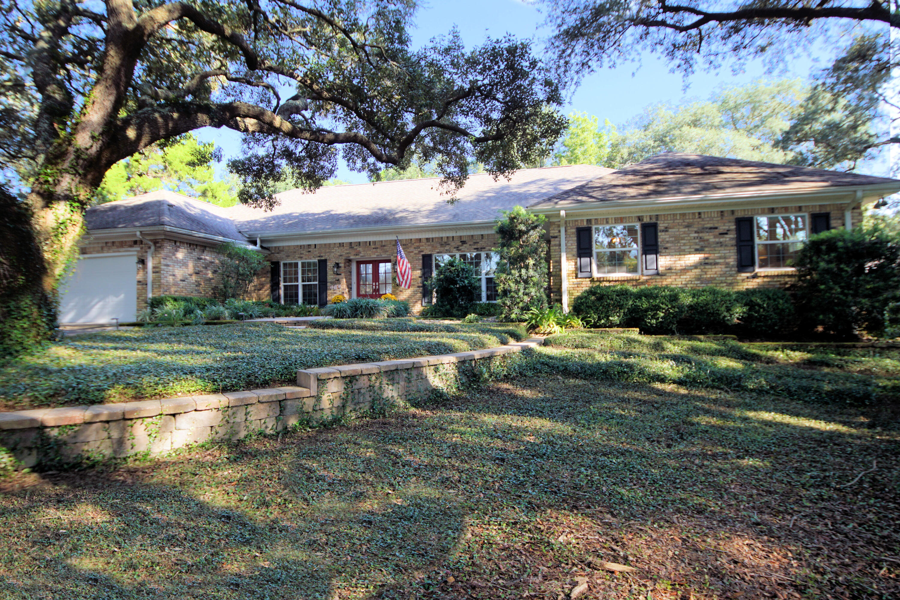 216 Country Club Road Shalimar, FL 32579 - Photo 2 of 59 a view of house with garden