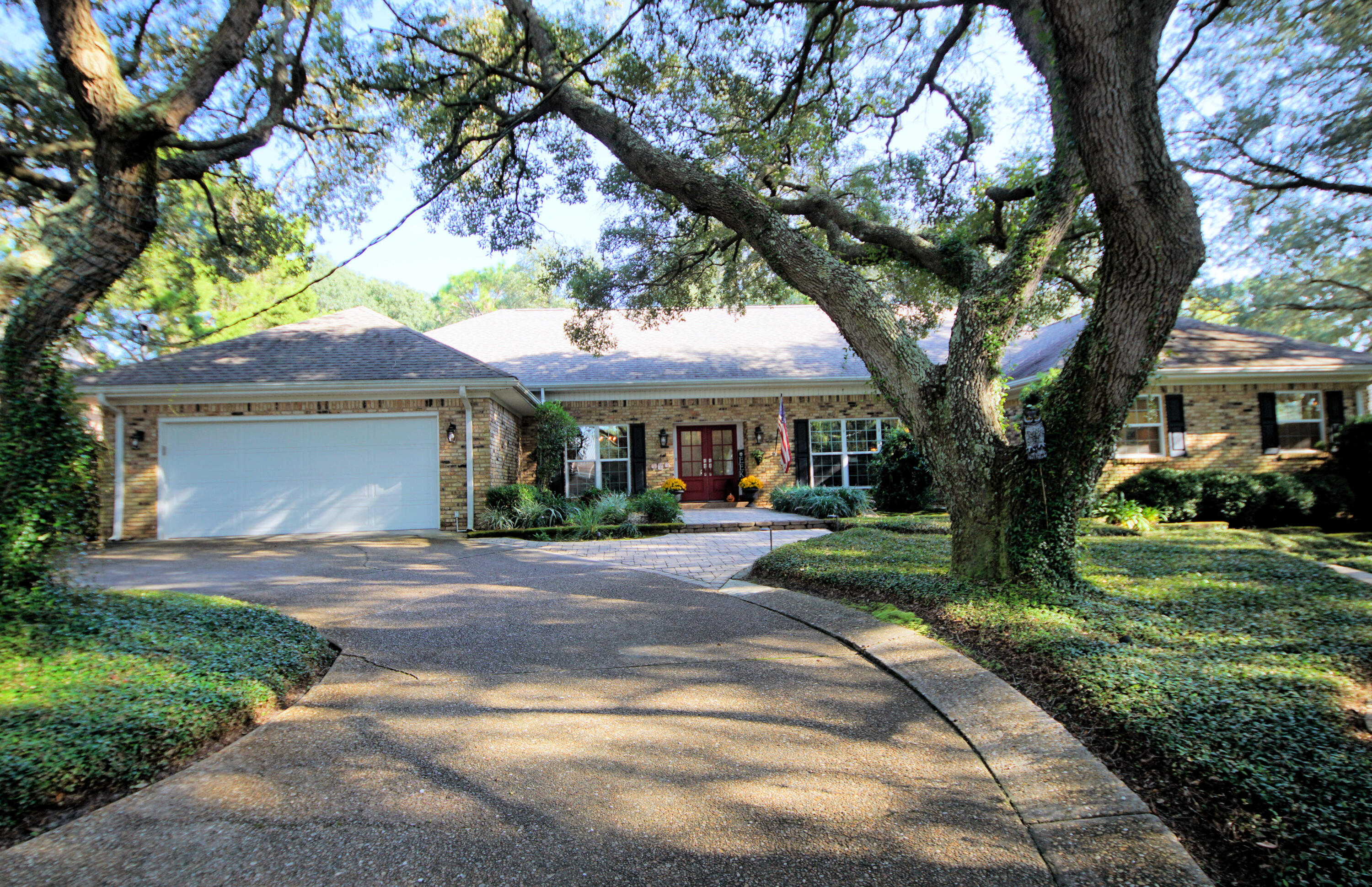 216 Country Club Road Shalimar, FL 32579 - Photo 3 of 59 a front view of a house with yard and green space