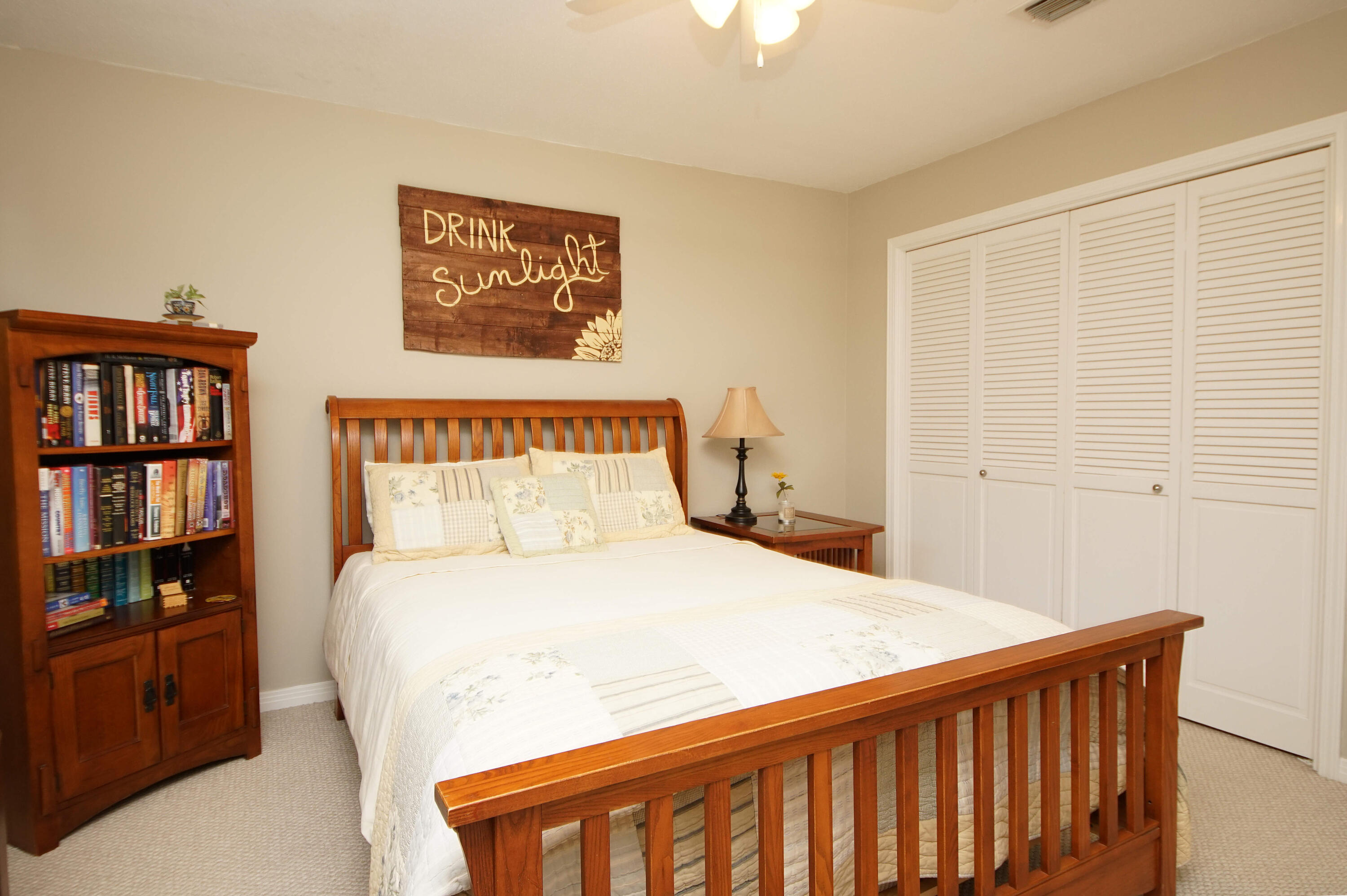 216 Country Club Road Shalimar, FL 32579 - Photo 42 of 59 a bedroom with a bed a book shelf and a window