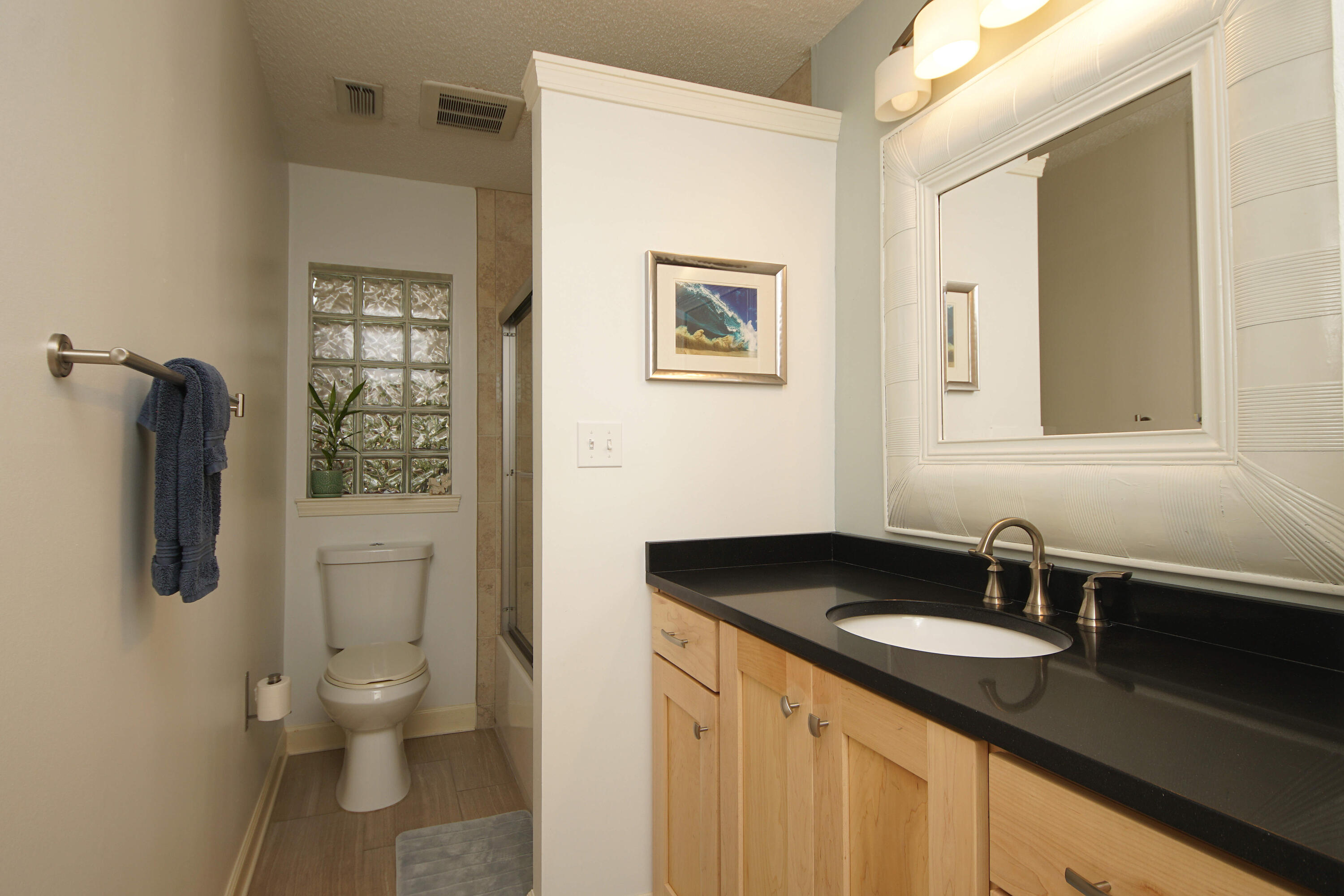 216 Country Club Road Shalimar, FL 32579 - Photo 43 of 59 a bathroom with a granite countertop sink toilet and shower