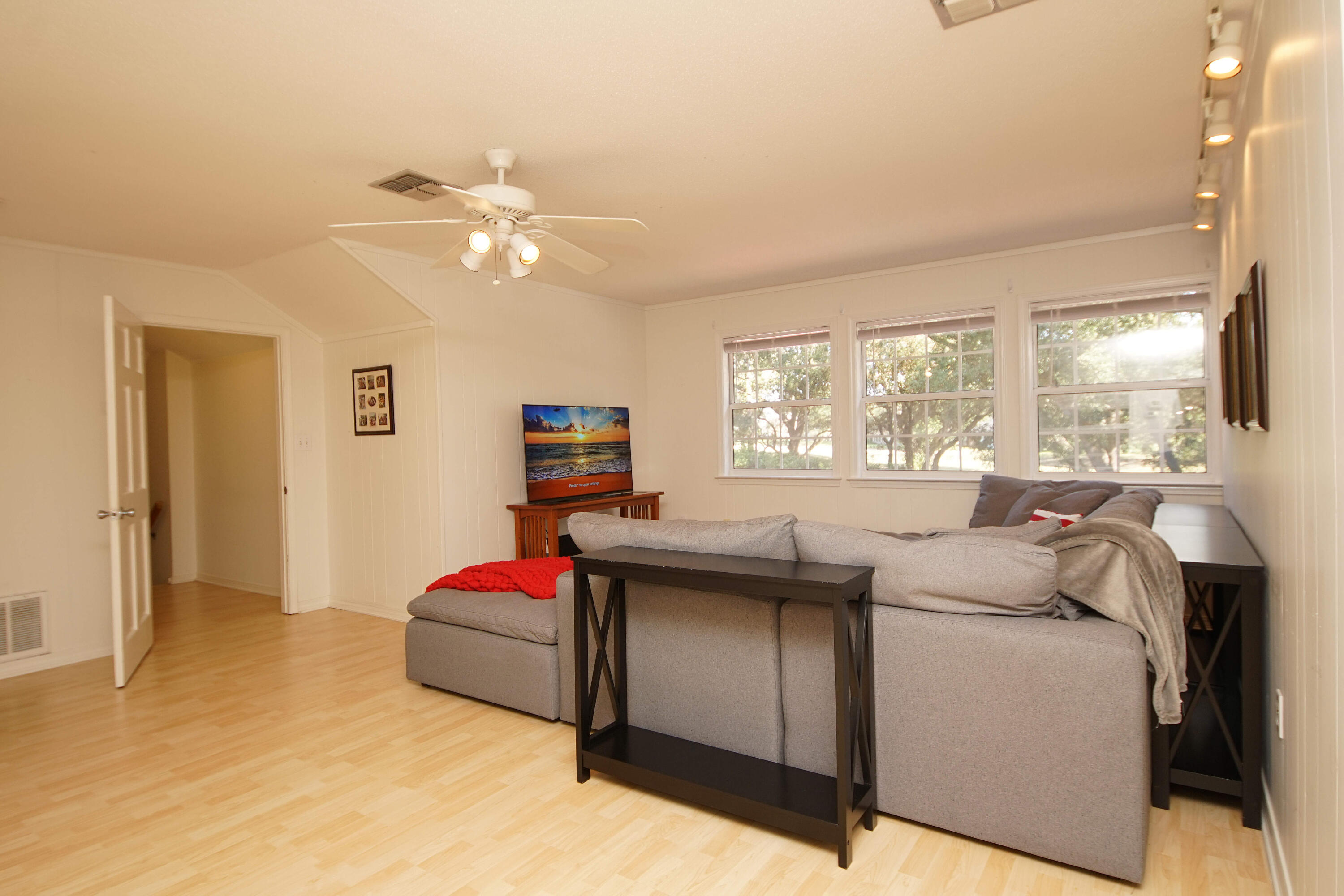 216 Country Club Road Shalimar, FL 32579 - Photo 45 of 59 a bedroom with a bed and a chandelier