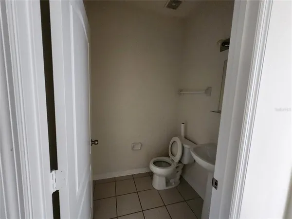 a white toilet sitting next to a bathroom sink