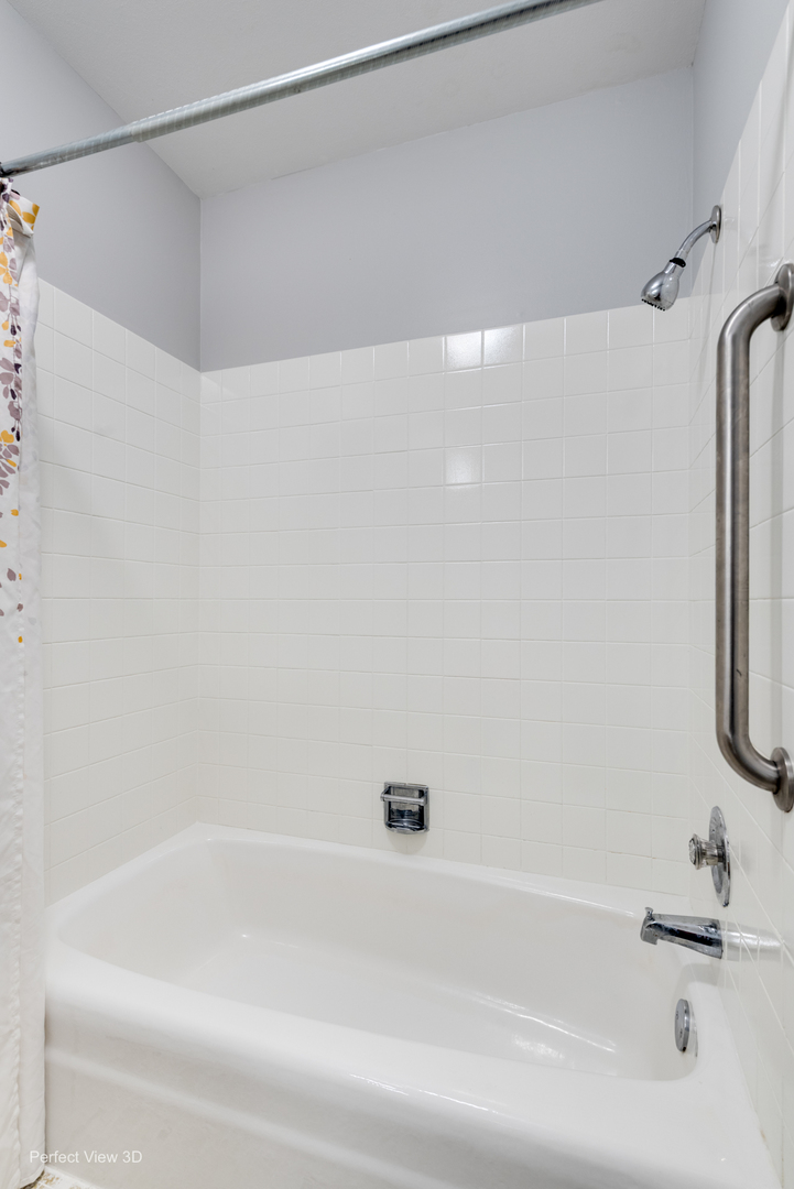 1003 West Hintz Road Arlington Heights, IL 60004 - Photo 14 of 27 a bathroom with a shower and a bath tub