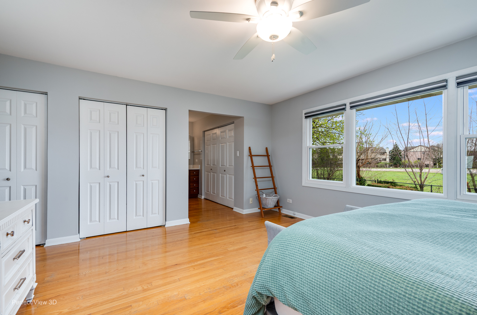 1003 West Hintz Road Arlington Heights, IL 60004 - Photo 19 of 27 a spacious bedroom with a large bed and a chandelier