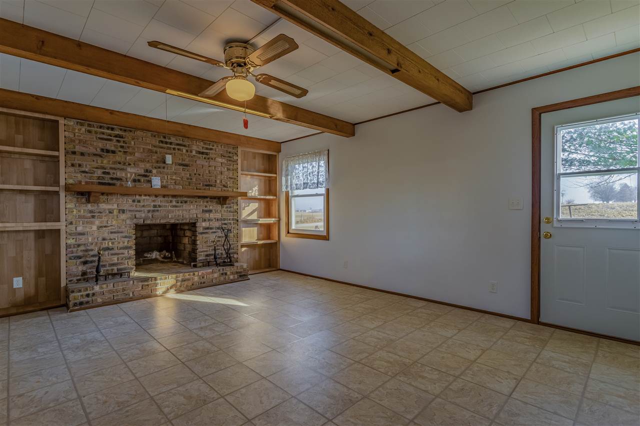 1091 West Buckeye Road Freeport, IL 61032 - Photo 5 of 25 a view of a livingroom with a fireplace and window
