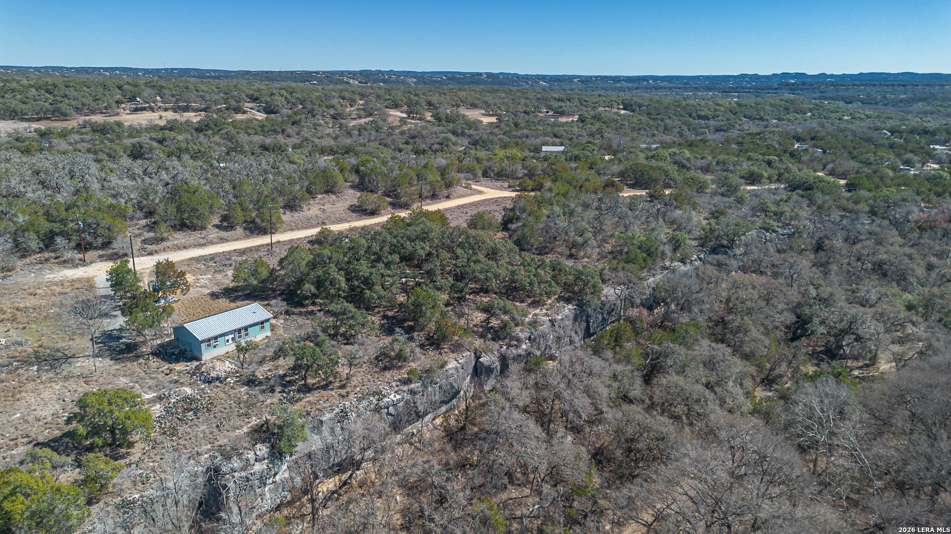 1076 Blue Bonnet Hl Drive Spring Branch, TX 78070 - Photo 26 of 44 an aerial view of residential houses with outdoor space and trees