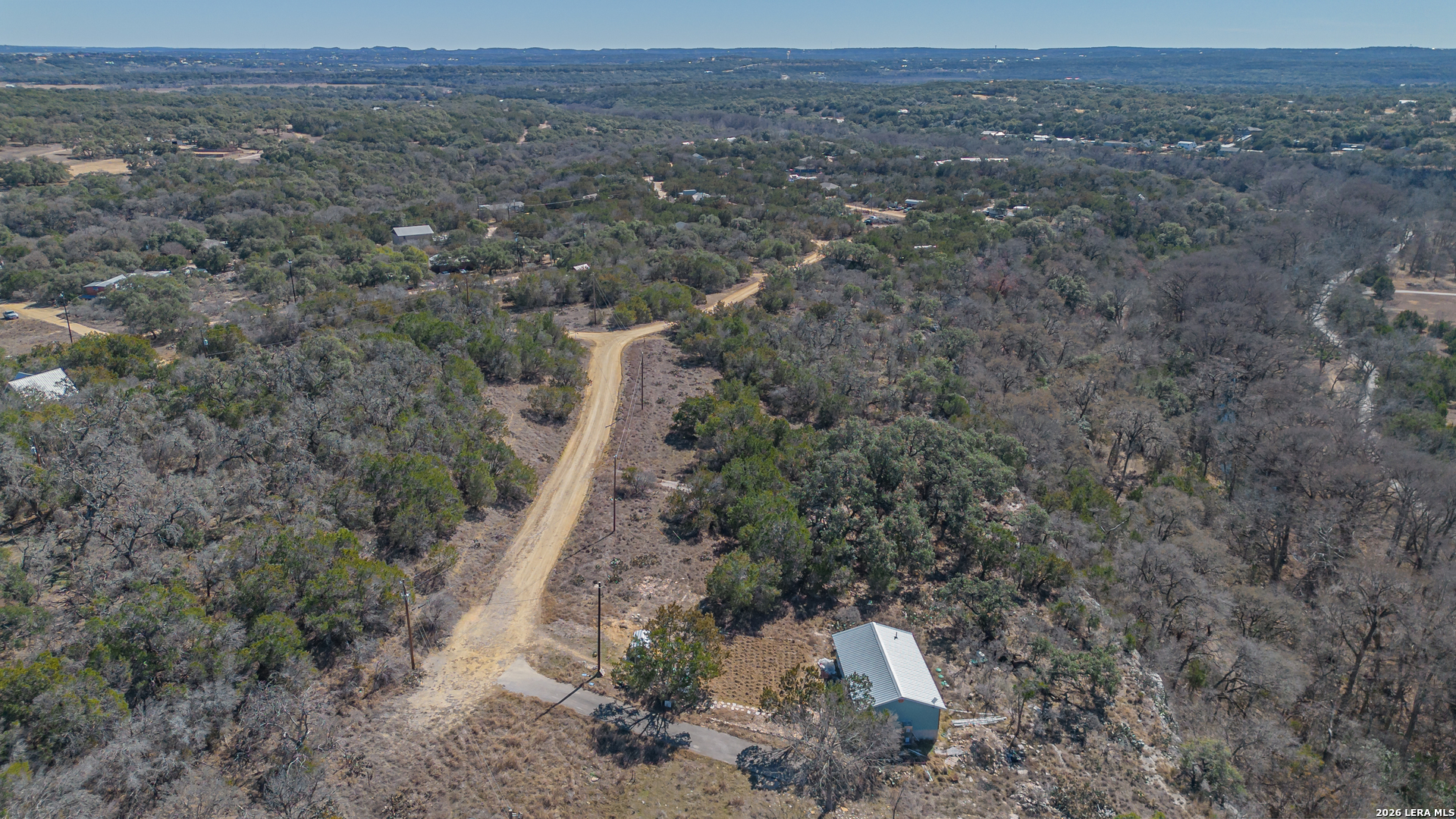 1076 Blue Bonnet Hl Drive Spring Branch, TX 78070 - Photo 38 of 44 a view of a field with trees and bushes
