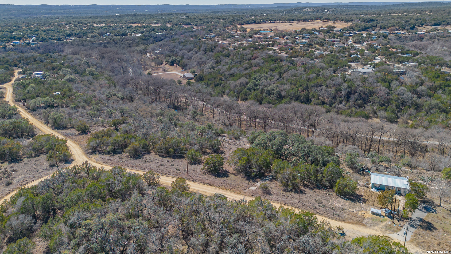 1076 Blue Bonnet Hl Drive Spring Branch, TX 78070 - Photo 40 of 44 an aerial view of house with yard and mountain in the background