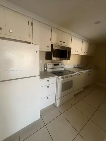 a kitchen with stainless steel appliances a stove refrigerator sink and cabinets