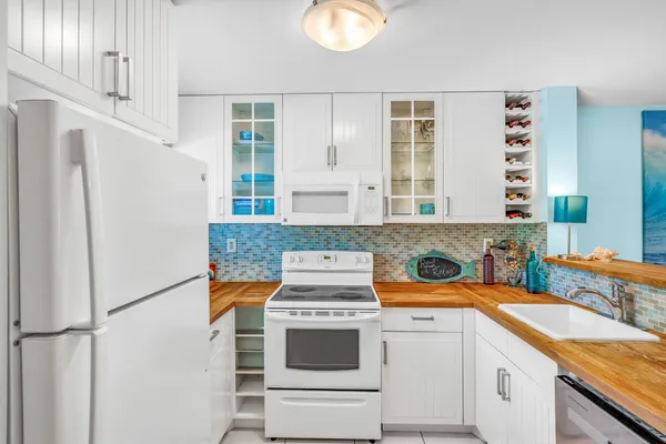 a kitchen with stainless steel appliances granite countertop a sink and a refrigerator