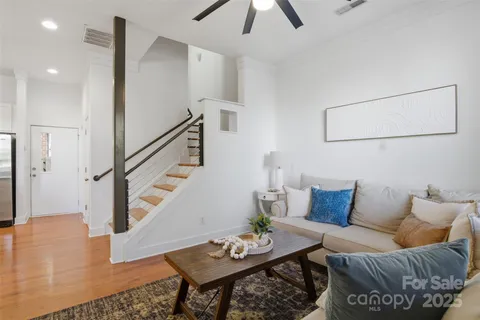 a living room with furniture and wooden floor