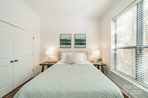 a bedroom with a large bed and a large window