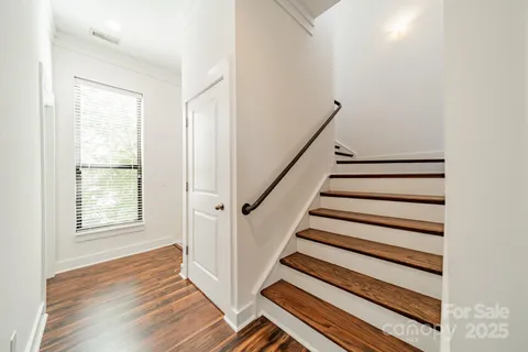 a view of entryway with wooden floor and stairs