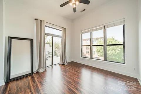 wooden floor chandelier and windows in a room