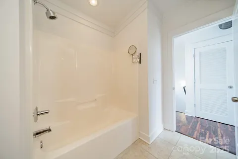 a bathroom with a bathtub and shower