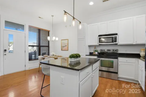 a kitchen with a sink stove and microwave