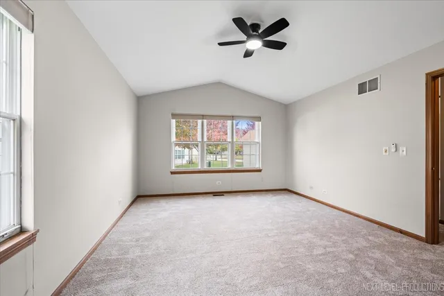 an empty room with windows and entrance