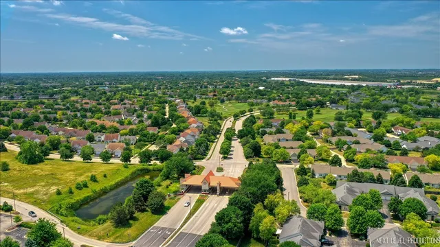 an aerial view of residential houses with outdoor space and trees