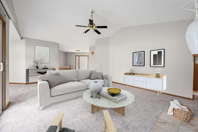 a living room with furniture and kitchen view
