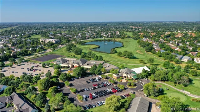an aerial view of residential houses with outdoor space and trees