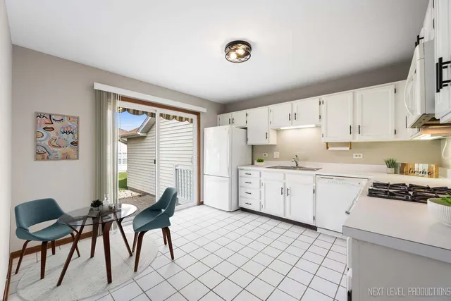 a kitchen with a cabinets a sink and appliances