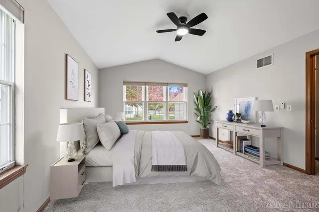 a bed room with a bed window and a chair