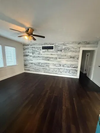 a view of water heater room with wooden floor