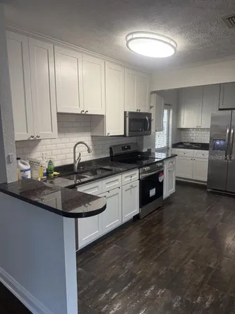 a kitchen with a sink stove and cabinets
