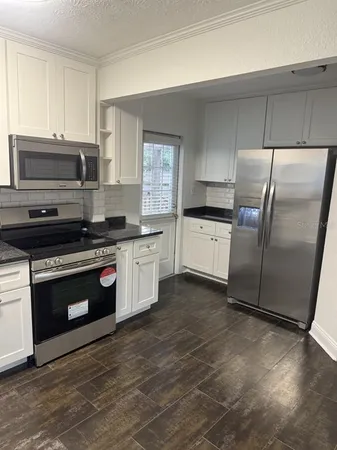 a kitchen with a stove a sink and a microwave