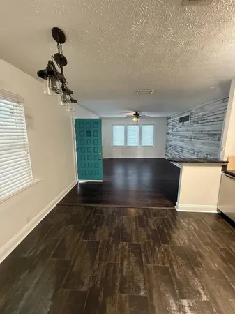 a view of wooden floor and a window in a room