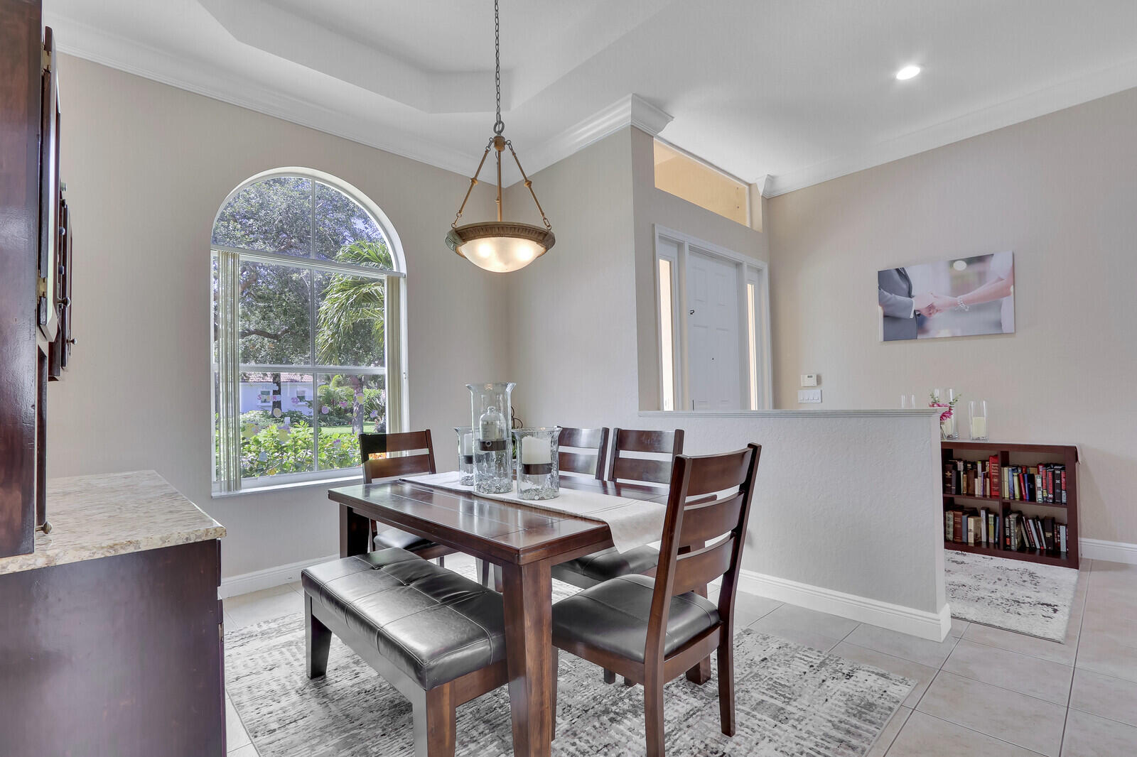 146 Magnolia Way Tequesta, FL 33469 - Photo 19 of 81 a dining room with furniture a chandelier and window