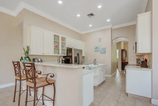 a view of a patio with couches table and chairs under an umbrella